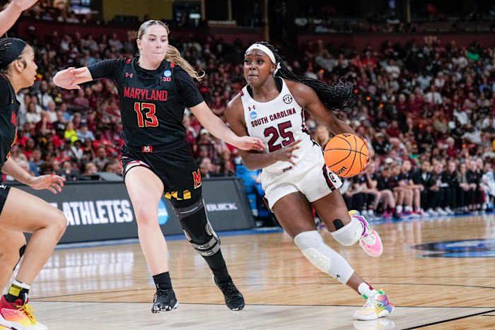 South Carolina Gamecocks guard Raven Johnson dribbles past Maryland Terrapins guard Faith Masonius.